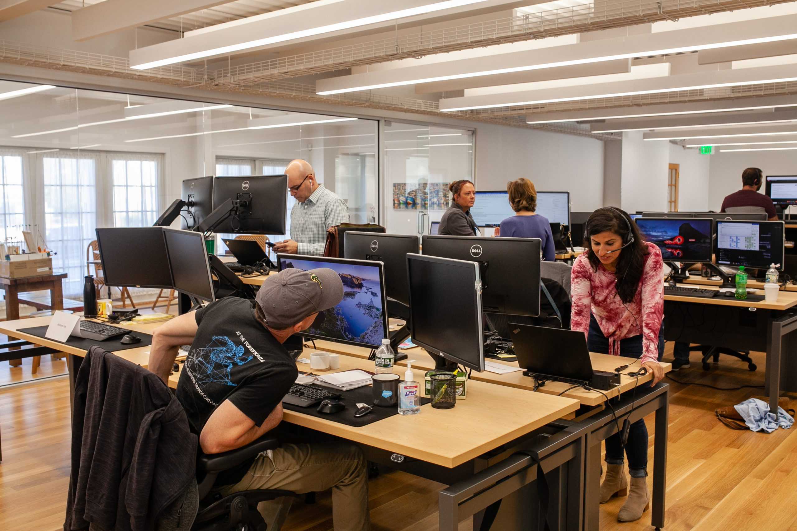 A diverse group of professionals collaborating in a modern open office space.