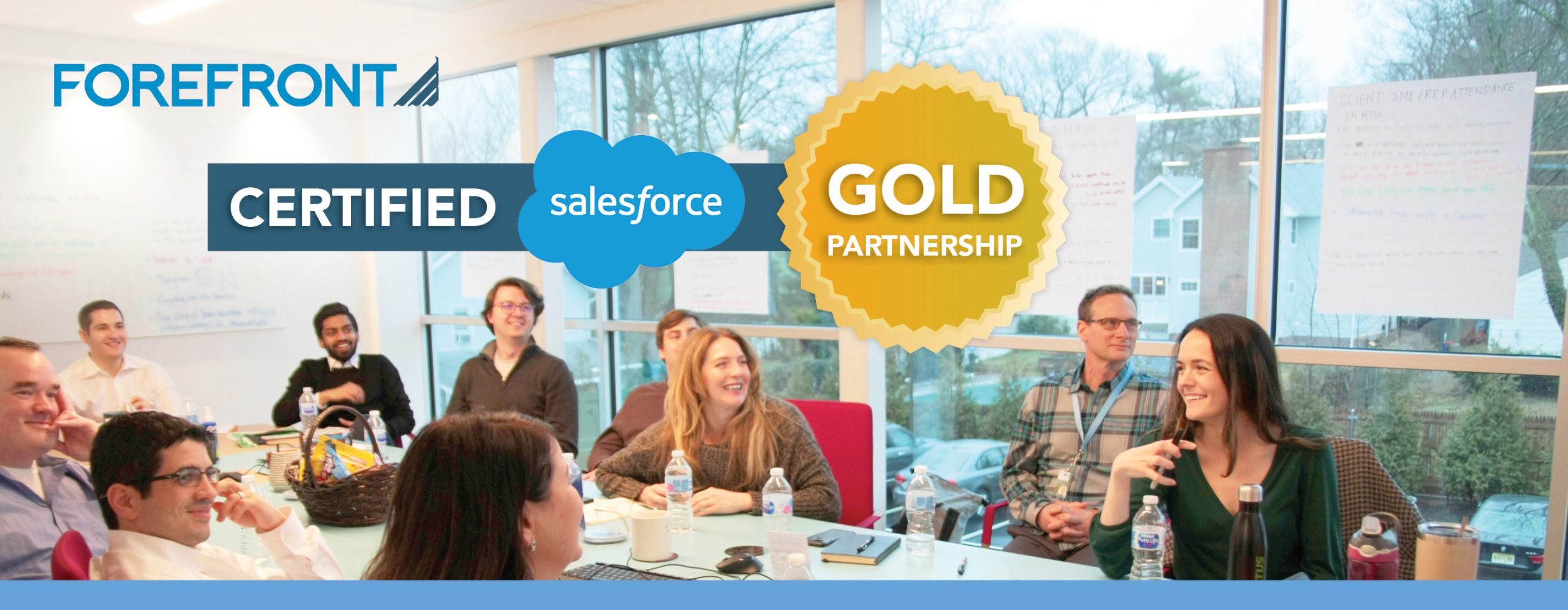 A banner that reads "ForeFront Certified Salesforce Gold Partnership" with a photo of colleagues laughing, smiling, and talking together in a brightly lit conference room.