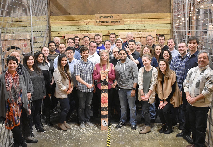 Careers_Photos_24_082719 Large A group photo of Team ForeFront at a team building event. There is a wooden sign on the back wall that reads Stompy's Ratchet House.