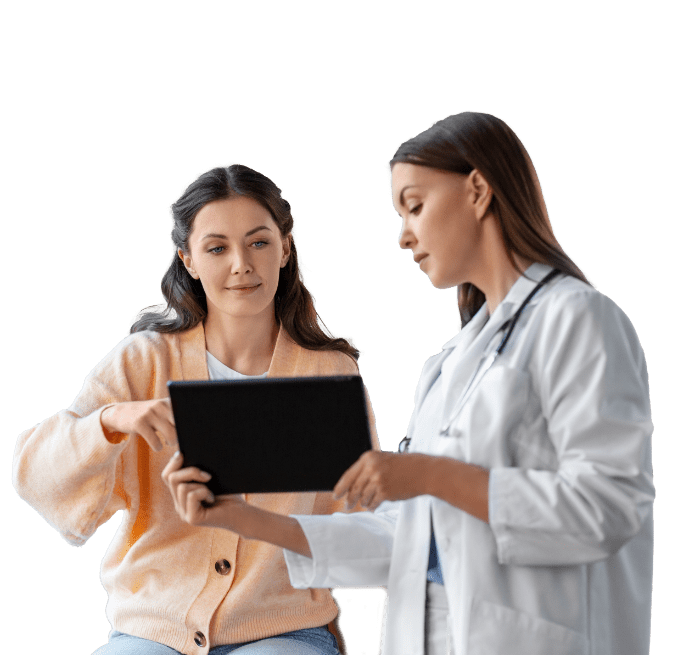 Female doctor showing a female patient information on a tablet.