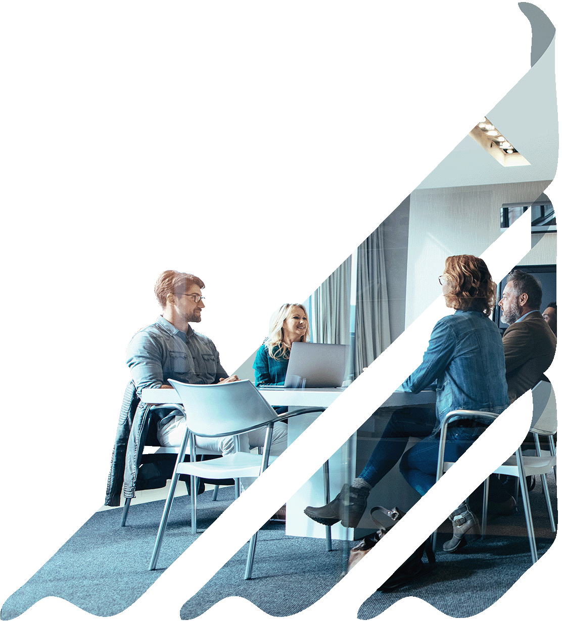 Website_Design_Services People sitting at a table in a meeting room, engaged in a discussion and sharing ideas.